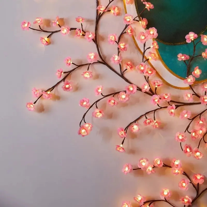 Decorative string lights shaped like cherry blossoms on a ceiling.